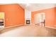 Spacious living room with a fireplace, carpet flooring, and archways that leads to other rooms at 4200 Vinca Way, Union City, GA 30291