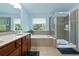 Elegant bathroom with double vanity, soaking tub, and glass enclosed shower at 1610 Apollo Dr, Suwanee, GA 30024