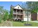 Two-story brick home with covered porch and well-maintained lawn at 1610 Apollo Dr, Suwanee, GA 30024