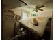 Cluttered bedroom with a ceiling fan and natural light from the window at 3617 Bob White Ln, Loganville, GA 30052