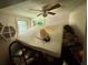 Cluttered bedroom with a ceiling fan and natural light from the window at 3617 Bob White Ln, Loganville, GA 30052