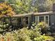 A charming single-story home with a covered porch and surrounded by lush greenery at 3617 Bob White Ln, Loganville, GA 30052