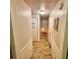 Long hallway with light wood floors leading to doorways at the end of the hall at 3617 Bob White Ln, Loganville, GA 30052