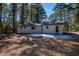 This backyard includes a concrete patio and wooded views at 380 Inman Rd, Fayetteville, GA 30215