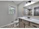 Bathroom features a modern vanity, wood look flooring and a window for natural light at 380 Inman Rd, Fayetteville, GA 30215