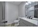 Bathroom features a modern vanity, new toilet, and tiled walls at 380 Inman Rd, Fayetteville, GA 30215