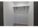 Walk-in closet with white walls, carpet flooring, and metal hanging rod at 380 Inman Rd, Fayetteville, GA 30215