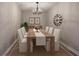 Formal dining room with a modern chandelier and seating for eight at 380 Inman Rd, Fayetteville, GA 30215