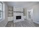 Bright living room with a white brick fireplace, built-ins and gray wood flooring at 380 Inman Rd, Fayetteville, GA 30215