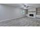 Bright living room featuring gray wood floors and a charming white brick fireplace at 380 Inman Rd, Fayetteville, GA 30215