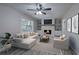 Bright living room featuring a brick fireplace, recessed lighting, and a modern ceiling fan at 380 Inman Rd, Fayetteville, GA 30215