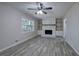 Inviting living room with gray wood floors, fan and a beautiful white brick fireplace at 380 Inman Rd, Fayetteville, GA 30215
