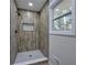 Updated shower with wood look tile, a window and a mosaic tiled shower floor at 380 Inman Rd, Fayetteville, GA 30215
