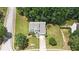 A beautiful suburban home from above displays its green lawn and perimeter of mature trees at 405 Rosedown Way, Lawrenceville, GA 30043