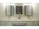 Bathroom featuring a vanity with double sinks, lighting fixtures, and a framed decorative picture at 405 Rosedown Way, Lawrenceville, GA 30043