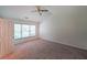 Neutral bedroom featuring large windows, a ceiling fan, and neutral carpeting at 405 Rosedown Way, Lawrenceville, GA 30043