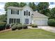 Charming two-story home with a manicured lawn, black shutters, and attached two car garage at 405 Rosedown Way, Lawrenceville, GA 30043