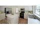 Bright kitchen featuring white cabinets, stainless steel appliances, and hardwood flooring at 405 Rosedown Way, Lawrenceville, GA 30043