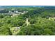 Private estate aerial view surrounded by lush landscape with a long drive and a tree house in a desirable neighborhood at 5885 Millstone Dr, Cumming, GA 30028