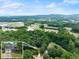 Aerial view of the home, showing its location surrounded by lush greenery and other homes at 5885 Millstone Dr, Cumming, GA 30028