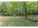 Bench seating looks onto the large backyard with a storage shed at the rear of the property at 5885 Millstone Dr, Cumming, GA 30028