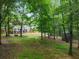 Large backyard featuring a patio deck, seating, a firepit area, and a storage shed at 5885 Millstone Dr, Cumming, GA 30028