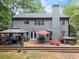 Elevated wooden deck featuring outdoor living space, dining area, hot tub, and umbrella-shaded table at 5885 Millstone Dr, Cumming, GA 30028