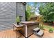 Outdoor hot tub on wooden deck with wooden privacy fence and lush greenery at 5885 Millstone Dr, Cumming, GA 30028