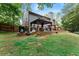 A beautiful deck features a covered pergola and grill overlooking the lush green backyard at 5885 Millstone Dr, Cumming, GA 30028