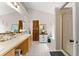 Bright bathroom featuring double sinks, stylish mirrors, and a glass-enclosed shower at 5885 Millstone Dr, Cumming, GA 30028