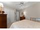 Relaxing bedroom with a comfortable bed, soft lighting, and ample closet space for storage at 5885 Millstone Dr, Cumming, GA 30028