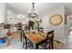 Charming dining area featuring a decorative chandelier, tile floors, and white kitchen cabinets in the background at 5885 Millstone Dr, Cumming, GA 30028