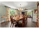 Inviting dining area with a chandelier, hardwood floors, and large windows offering lots of natural light at 5885 Millstone Dr, Cumming, GA 30028
