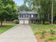 Well-maintained two-story home with a classic design, a two-car garage, and a manicured front lawn at 5885 Millstone Dr, Cumming, GA 30028