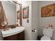 Cozy half bathroom featuring modern sink, classic wall art, and updated fixtures at 5885 Millstone Dr, Cumming, GA 30028