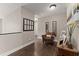Inviting hallway with stylish decor, hardwood floors, and a cozy chair, creating a warm ambiance at 5885 Millstone Dr, Cumming, GA 30028