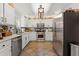 Modern kitchen with white cabinets, stainless steel appliances, and granite countertops at 5885 Millstone Dr, Cumming, GA 30028