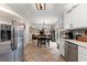 Modern kitchen with stainless steel appliances, tile flooring, and a seamless flow to the adjacent dining area at 5885 Millstone Dr, Cumming, GA 30028