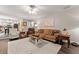 Bright and airy living room with hardwood floors, fireplace, and open access to kitchen at 5885 Millstone Dr, Cumming, GA 30028