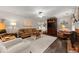 Spacious living room with a comfortable seating area, fireplace, and stylish decor at 5885 Millstone Dr, Cumming, GA 30028
