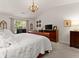 Main bedroom with vaulted ceilings, chandelier, and abundant natural light from large windows at 5885 Millstone Dr, Cumming, GA 30028