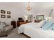 Bright main bedroom with vaulted ceilings, chandelier, and comfortable seating area at 5885 Millstone Dr, Cumming, GA 30028