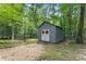 Storage shed with double doors and wreath decorations sits at the rear of the property at 5885 Millstone Dr, Cumming, GA 30028