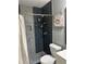 This bathroom features stylish tile in the shower, a flower painting, and ample storage at 6658 Ramsgate Way, Norcross, GA 30093