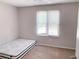 This cozy bedroom features neutral paint, carpet, and a window providing natural light at 6658 Ramsgate Way, Norcross, GA 30093
