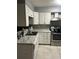 Functional kitchen featuring modern appliances, ample counter space, and white cabinets at 6658 Ramsgate Way, Norcross, GA 30093