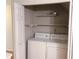 This closet contains a newer washer and dryer and multiple storage shelves at 6658 Ramsgate Way, Norcross, GA 30093