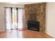 Living room featuring a stone fireplace and sliding doors to the patio at 6658 Ramsgate Way, Norcross, GA 30093