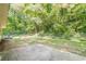 Backyard with concrete patio, chain link fence, and dense tree line at 109 Amberidge Nw Dr, Cartersville, GA 30121