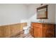 A bathroom with wood paneled walls and an updated vanity area with a dark countertop at 109 Amberidge Nw Dr, Cartersville, GA 30121